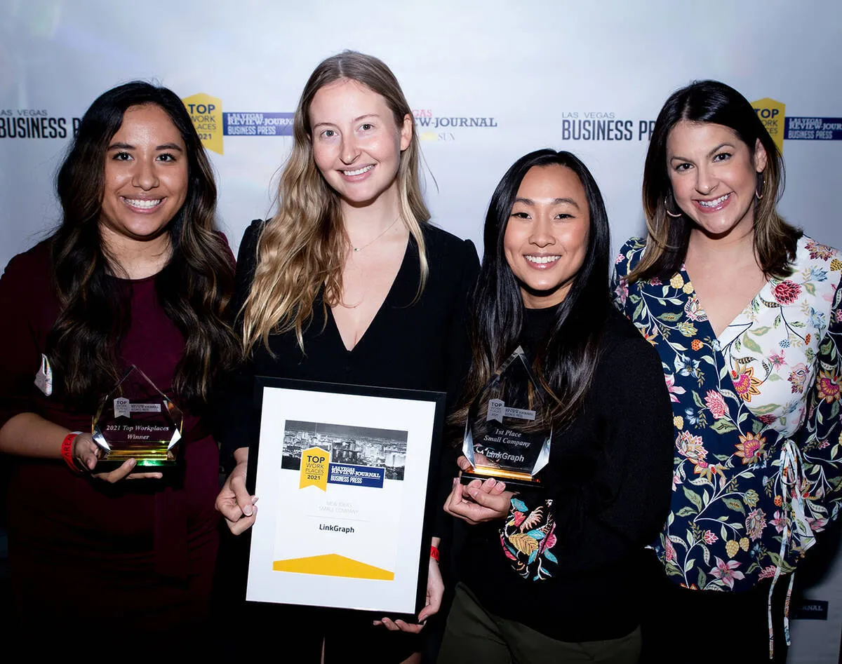 Four women posing for a photo with their awards at a Top Workplaces event in Nevada.