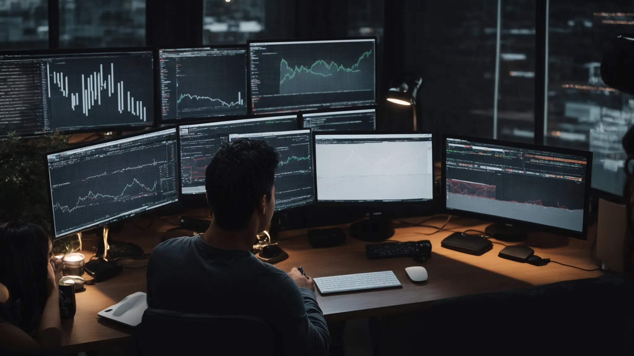 a person working on a computer with multiple screens displaying analytics graphs and keyword research tools.